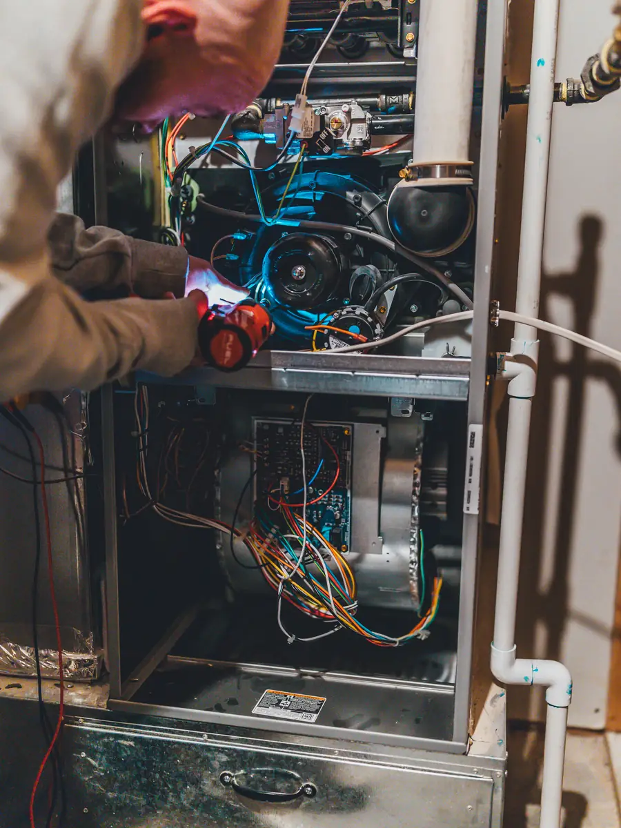 Technician checking furnace parts during a tune-up