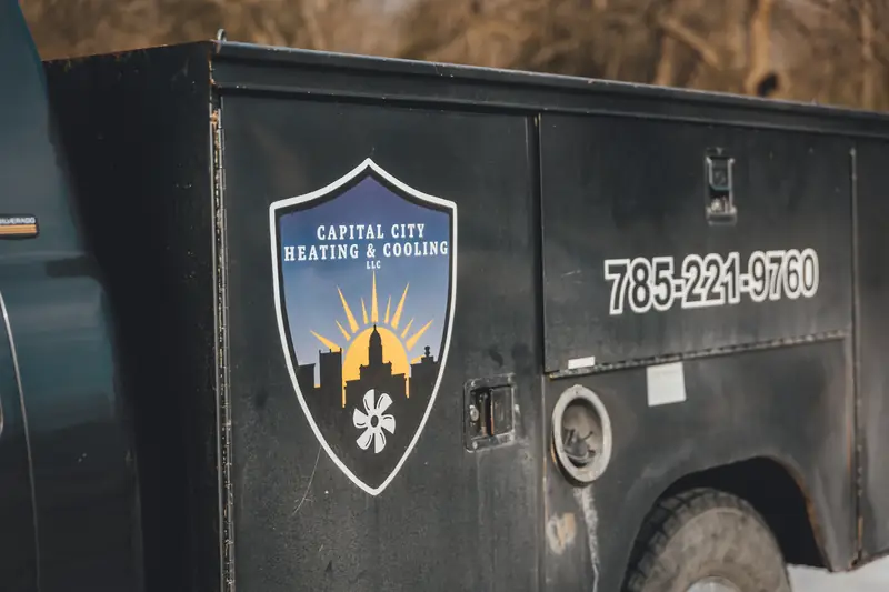Capital City service truck with the shield logo and phone number